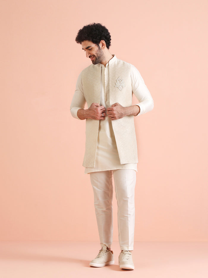 The model is standing straight, posing confidently in Kisah's Cream Silk Blend Embroidered Jacket Set for men