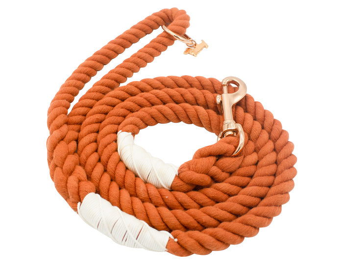 The Sassy Woof Dog Rope Leash - Athens is a coiled, thick orange cotton leash with white wrapped accents and a chic rose gold clasp.