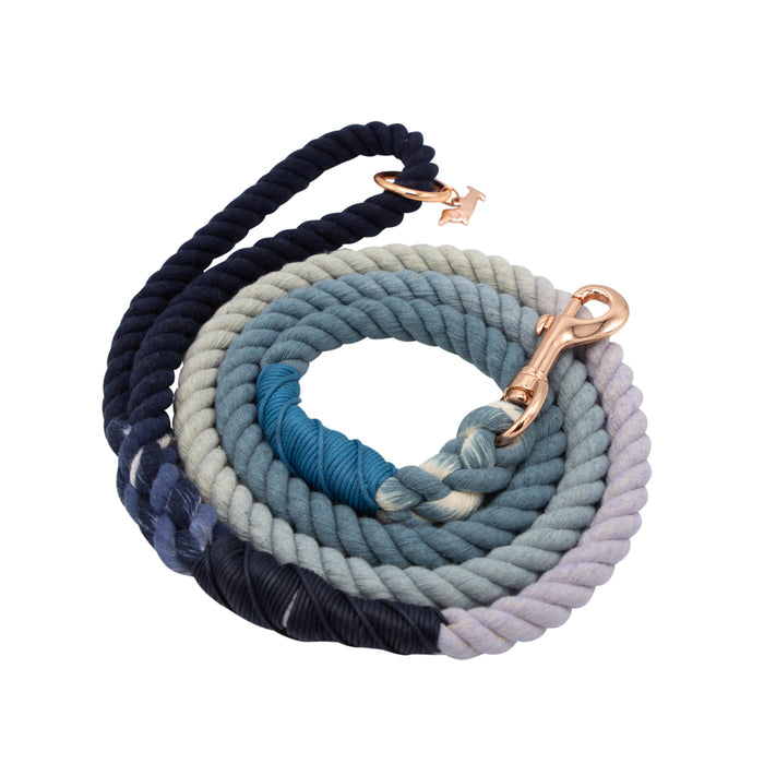 The Sassy Woof Dog Rope Leash - Oasis is a hand-crafted ombre blue and white cotton leash with a rose gold clasp and small “H” charm, shown on a white background.