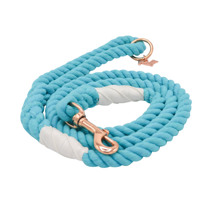 The Sassy Woof Dog Rope Leash - Seaside features a coiled turquoise design with white accents and rose gold hardware, shown on a white background.