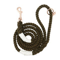 The Sassy Woof Dog Rope Leash - Walnut features a coiled dark green cotton rope with white thread accents and a rose gold metal clasp and ring, displayed on a white background.