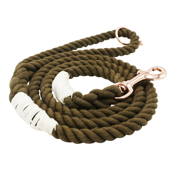 The Sassy Woof Dog Rope Leash - Walnut features a coiled brown rope with a copper-colored clasp and two white tape-wrapped sections for reinforcement, shown on a white background.
