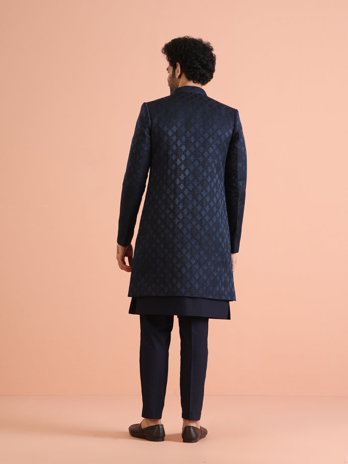 The back view of the model highlights Kisah's Navy Blue Silk Blend Indo Western Sherwani Set for men clearly